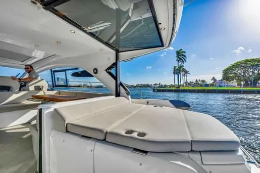 Slide: The Image of 2023 Beneteau Gran Turismo 45 yacht interior with waterfront view and sunny skies. - 10
