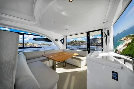 Slide: The Image of Interior of 2023 Beneteau Gran Turismo 45 yacht with elegant seating and ocean view. - 17