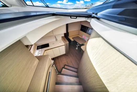 Slide: The Image of Interior view of 2023 Beneteau Gran Turismo 45 yacht, featuring modern kitchen and seating area. - 25