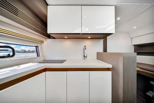 Slide: The Image of Modern kitchen interior on 2023 Beneteau Gran Turismo 45 yacht, featuring sleek cabinetry and minimalist design. - 27