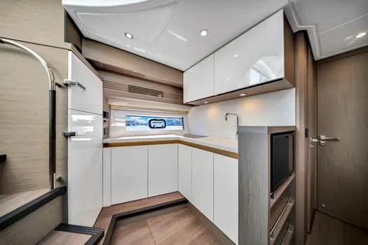 Slide: The Image of Modern kitchen interior of 2023 Beneteau Gran Turismo 45 yacht, featuring sleek cabinetry and appliances. - 28