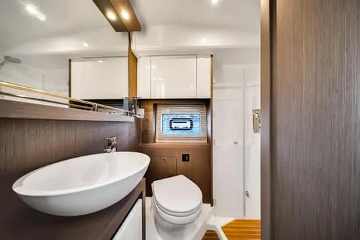 Slide: The Image of Luxurious bathroom interior of 2023 Beneteau Gran Turismo 45 yacht, featuring modern fixtures and wood accents. - 37