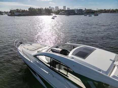Slide: The Image of 2023 Beneteau Gran Turismo 45 yacht cruising on a sunny waterfront. - 4