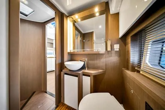 Slide: The Image of Luxurious bathroom interior of 2023 Beneteau Gran Turismo 45 yacht, featuring modern fixtures and wood accents. - 41