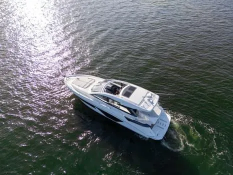 Slide: The Image of 2023 Beneteau Gran Turismo 45 yacht cruising on open water, aerial view. - 46