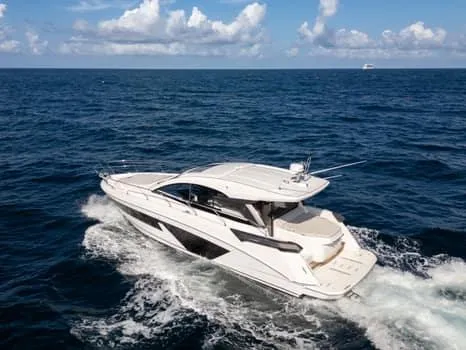 Slide: The Image of 2023 Beneteau Gran Turismo 45 yacht cruising on open sea under blue sky. - 48