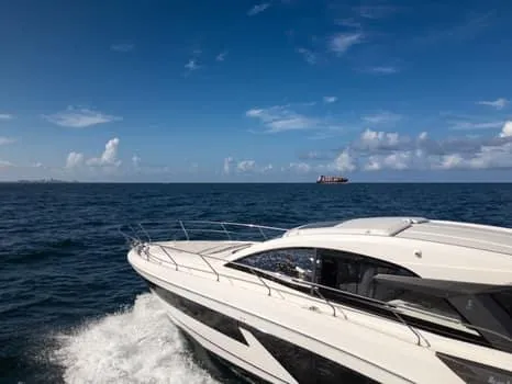 Slide: The Image of 2023 Beneteau Gran Turismo 45 yacht cruising on open sea under clear blue sky. - 49
