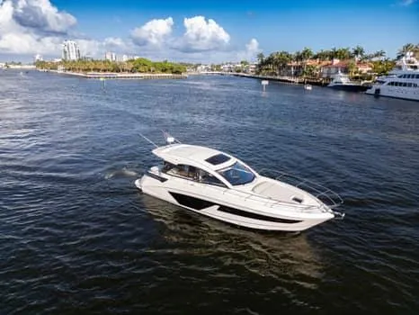 Slide: The Image of 2023 Beneteau Gran Turismo 45 yacht cruising on a scenic waterway. - 6