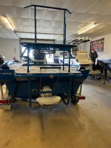Slide: The Image of 2022 RIVER RAPTOR XR8 2072 boat in garage, rear view, blue color, elevated platform. - 3