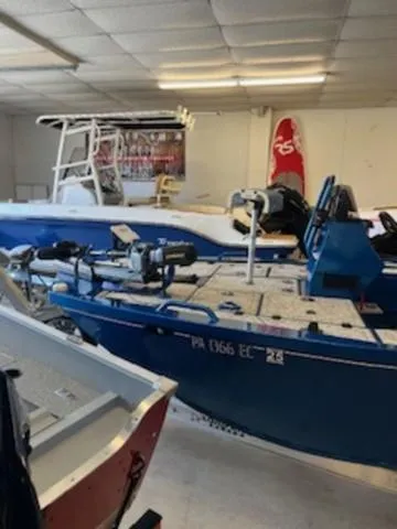 Slide: The Image of 2022 RIVER RAPTOR XR8 2072 boat in showroom, blue exterior, indoor display. - 4