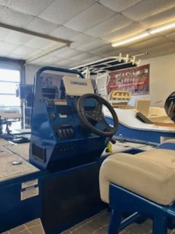 Slide: The Image of 2022 RIVER RAPTOR XR8 2072 boat interior with steering console in showroom. - 5