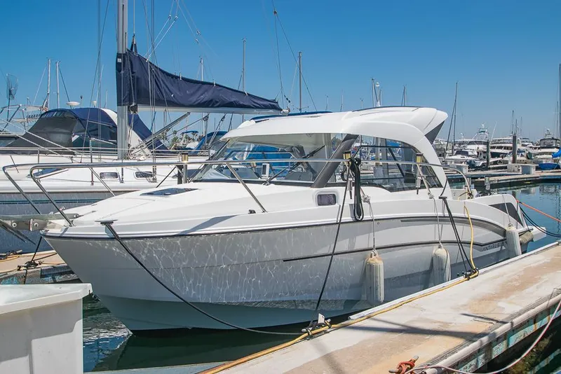 Slide: The Image of 2021 Beneteau Antares 8 boat docked in marina under clear blue sky. - 0
