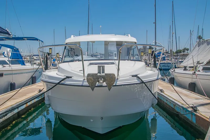 Slide: The Image of 2021 Beneteau Antares 8 docked in a marina, front view. - 1