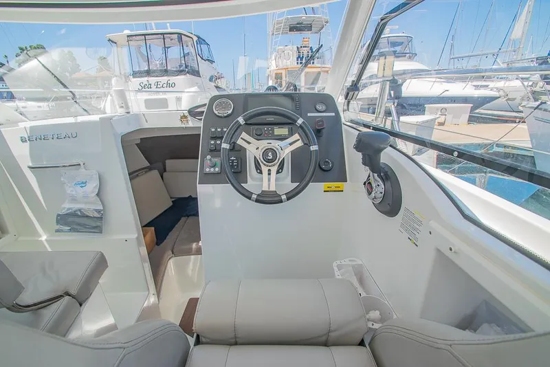 Slide: The Image of Interior view of 2021 Beneteau Antares 8 boat cockpit with steering wheel and controls. - 13