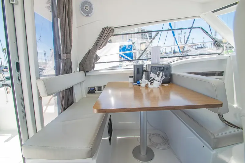 Slide: The Image of Interior of 2021 Beneteau Antares 8 with dining area and large windows. - 19