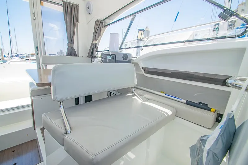 Slide: The Image of Interior of 2021 Beneteau Antares 8 boat, featuring modern seating and large windows. - 21