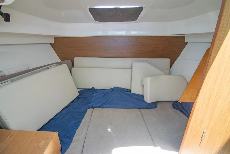 Slide: The Image of Interior cabin of 2021 Beneteau Antares 8 with cushions and blue cover. - 25
