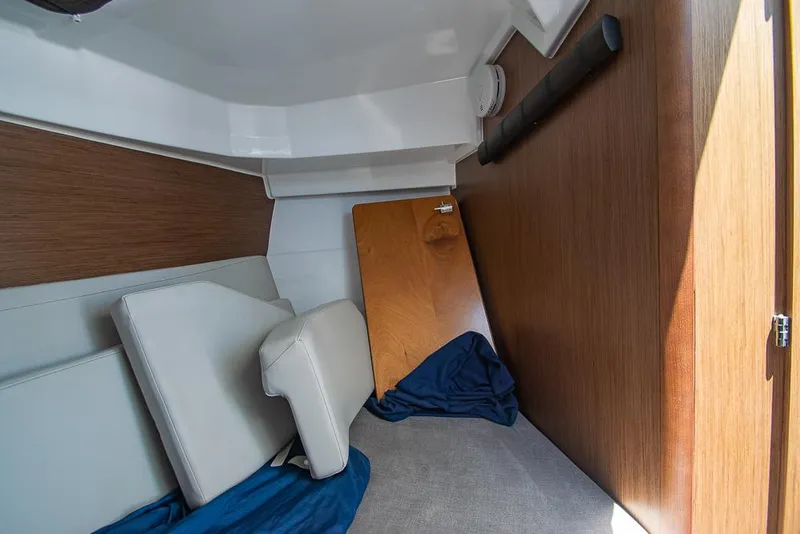 Slide: The Image of Interior cabin of 2021 Beneteau Antares 8 with cushions and wooden panel. - 26
