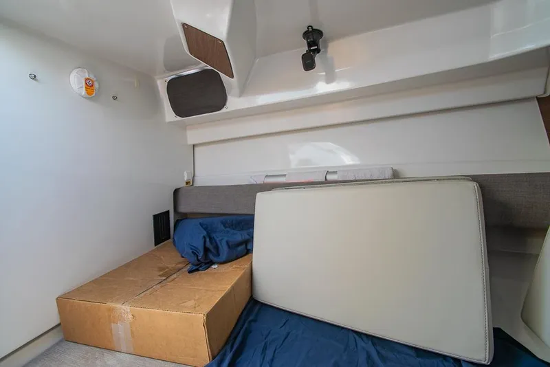 Slide: The Image of Interior cabin of 2021 Beneteau Antares 8 with cushions and a cardboard box. - 27