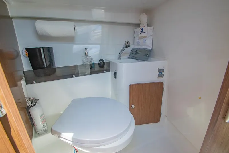 Slide: The Image of 2021 Beneteau Antares 8 bathroom with toilet, sink, and storage cabinet. - 29