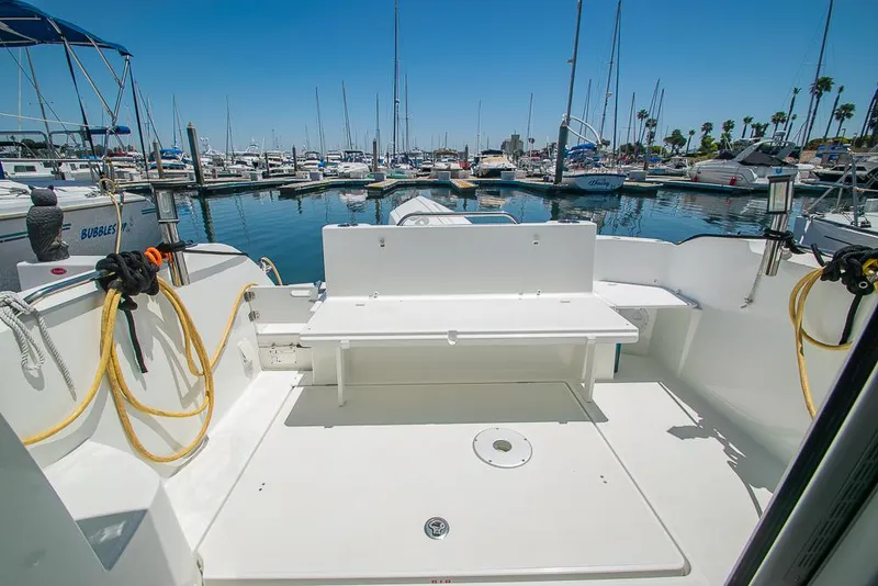 Slide: The Image of Beneteau Antares 8 (2021) boat deck at marina, surrounded by sailboats under clear blue sky. - 31