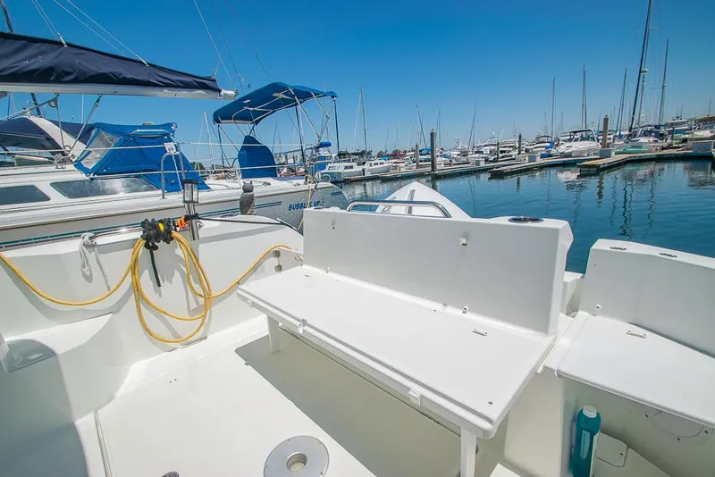 Slide: The Image of Beneteau Antares 8 (2021) boat deck at marina, featuring seating and mooring equipment. - 34