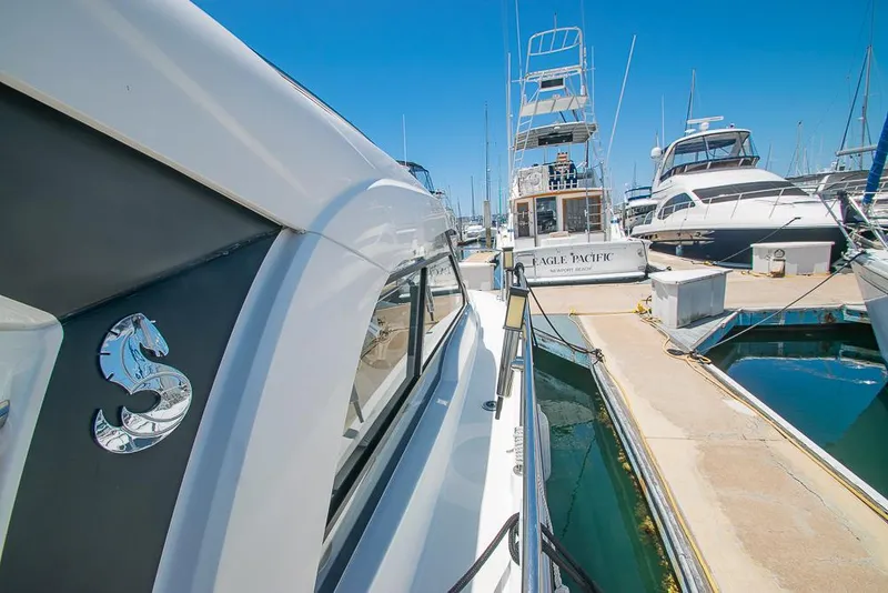 Slide: The Image of Beneteau Antares 8, 2021 model, docked at a marina with other boats under clear blue sky. - 35