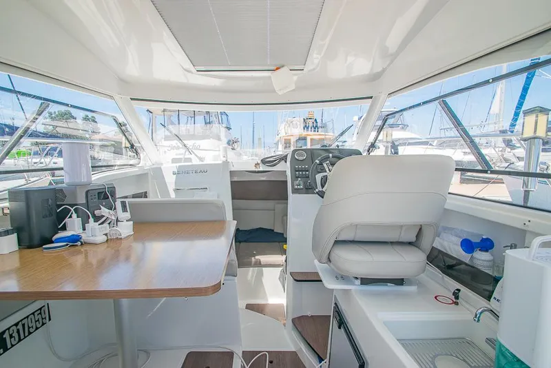 Slide: The Image of Interior of 2021 Beneteau Antares 8 boat, featuring helm, seating, and table. - 8