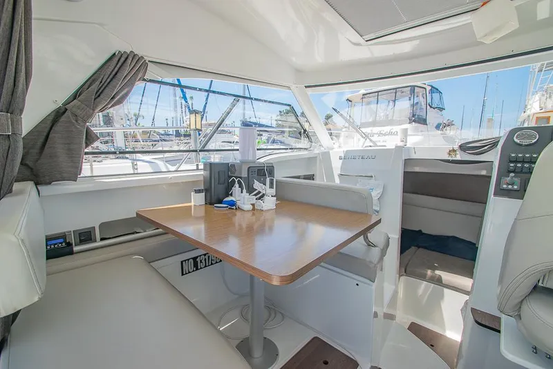 Slide: The Image of Interior of 2021 Beneteau Antares 8 boat with dining table and seating area. - 9