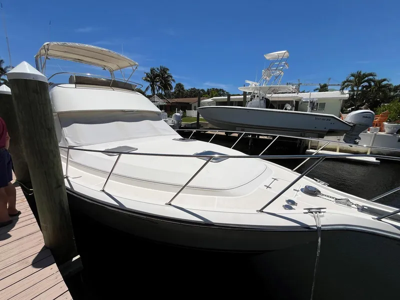 Slide: The Image of 1994 Tiara Yachts 3600 Convertible Sportfish docked under clear blue sky. - 15