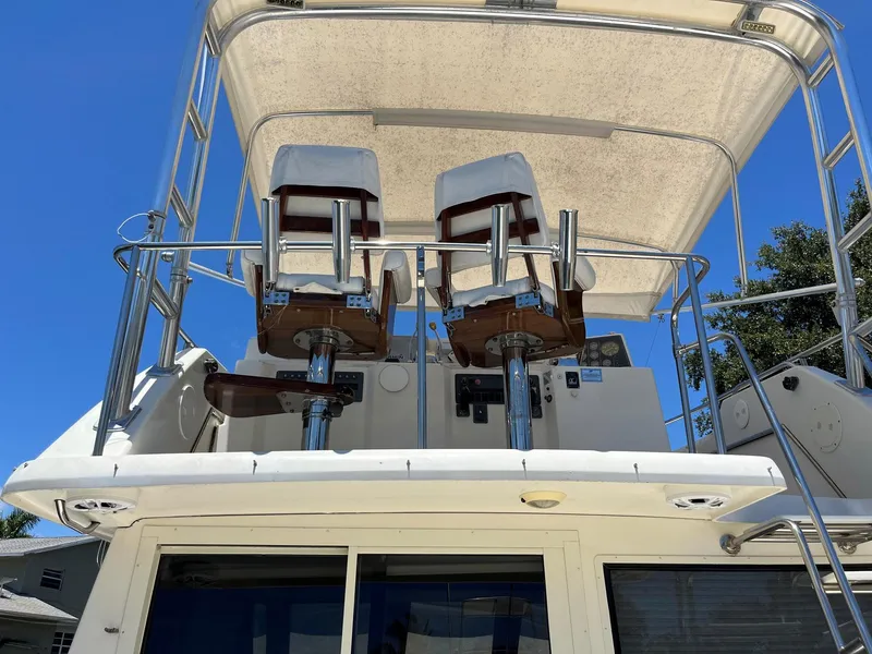 Slide: The Image of 1994 Tiara Yachts 3600 Convertible Sportfish, upper deck with two captain chairs under canopy. - 22