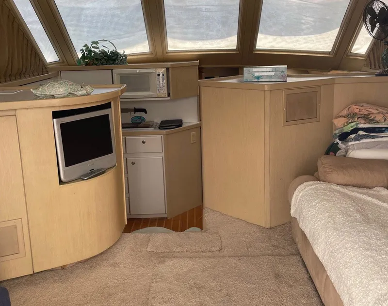 Slide: The Image of Interior of 1994 Tiara Yachts 3600 Convertible Sportfish with TV, microwave, and cozy seating. - 4