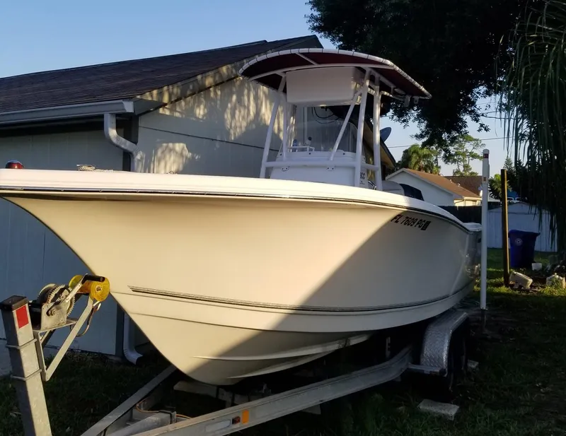 Slide: The Image of 2012 Tidewater 220 CC Adventure boat on trailer beside house. - 3