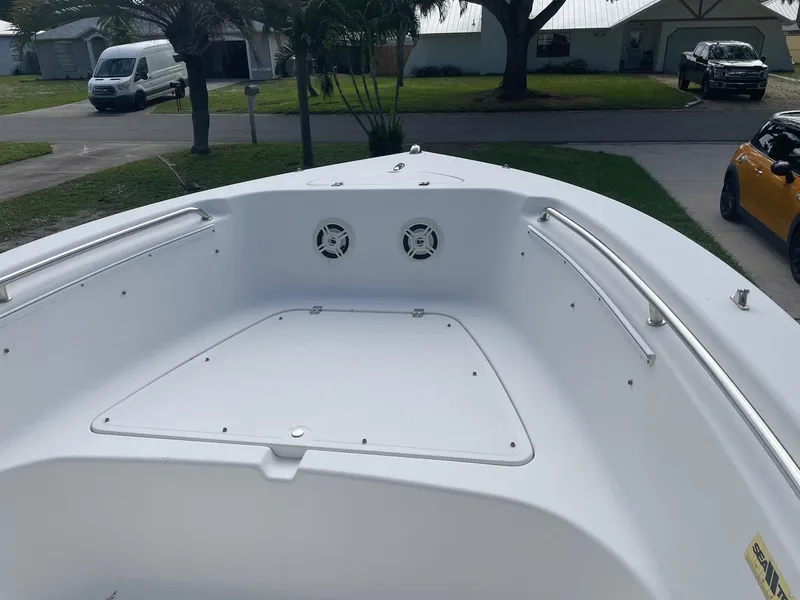 Slide: The Image of 2012 Tidewater 220 CC Adventure boat bow with stainless steel rails and storage hatch. - 4