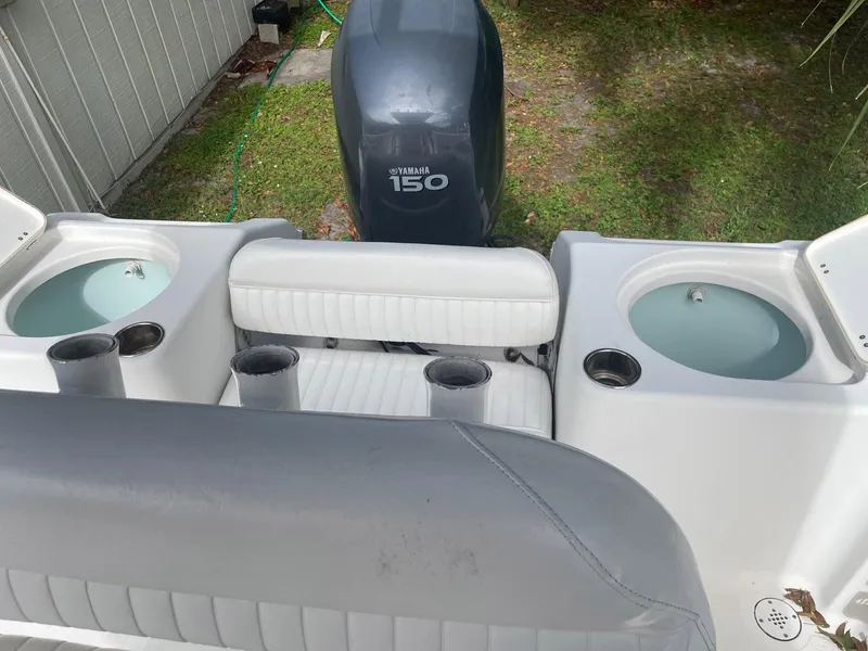 Slide: The Image of 2012 Tidewater 220 CC Adventure boat with Yamaha 150 engine, featuring dual livewells and seating. - 8
