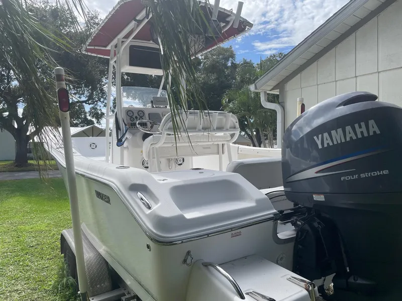 Slide: The Image of 2012 Tidewater 220 CC Adventure boat with Yamaha engine, parked on grass. - 9