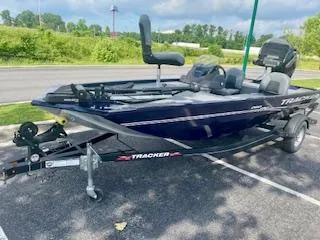 Slide: The Image of 2022 Tracker Pro 170 boat on trailer in parking lot, sunny day. - 2