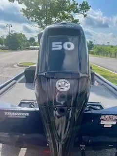 Slide: The Image of 2022 Tracker Pro 170 boat with a 50 HP Mercury engine in a parking lot. - 7