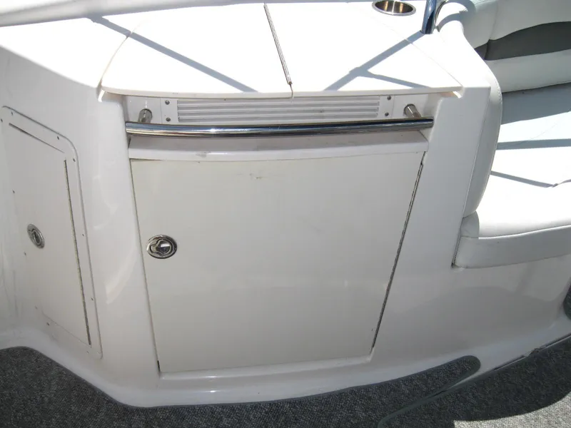 Slide: The Image of 2005 Chaparral 280 SSi boat interior with storage compartment and seating area. - 10