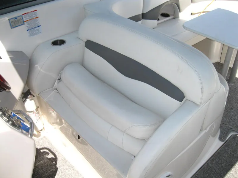 Slide: The Image of 2005 Chaparral 280 SSi boat interior with white seating and cup holder. - 13