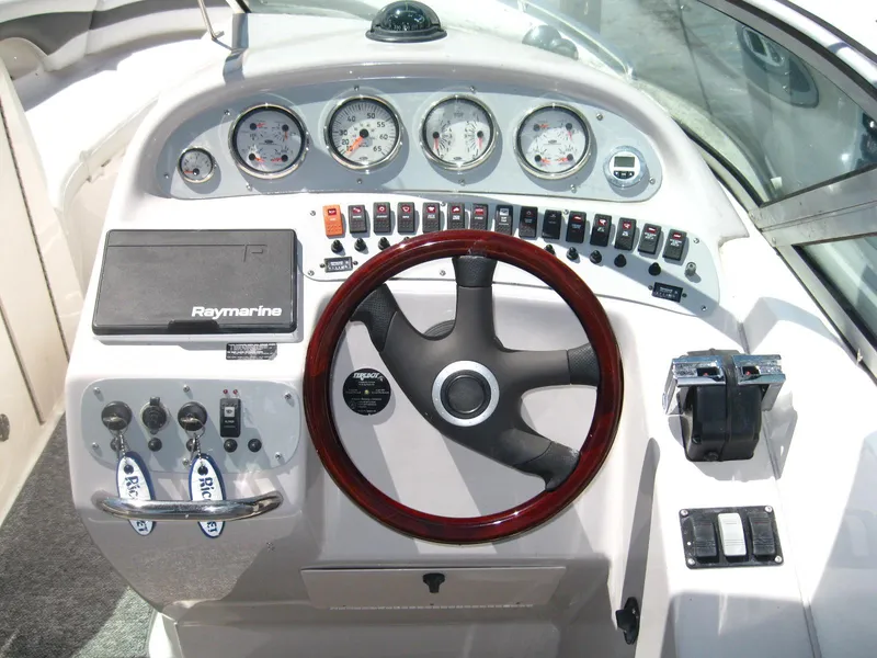 Slide: The Image of 2005 Chaparral 280 SSi boat dashboard with steering wheel and control panel. - 14