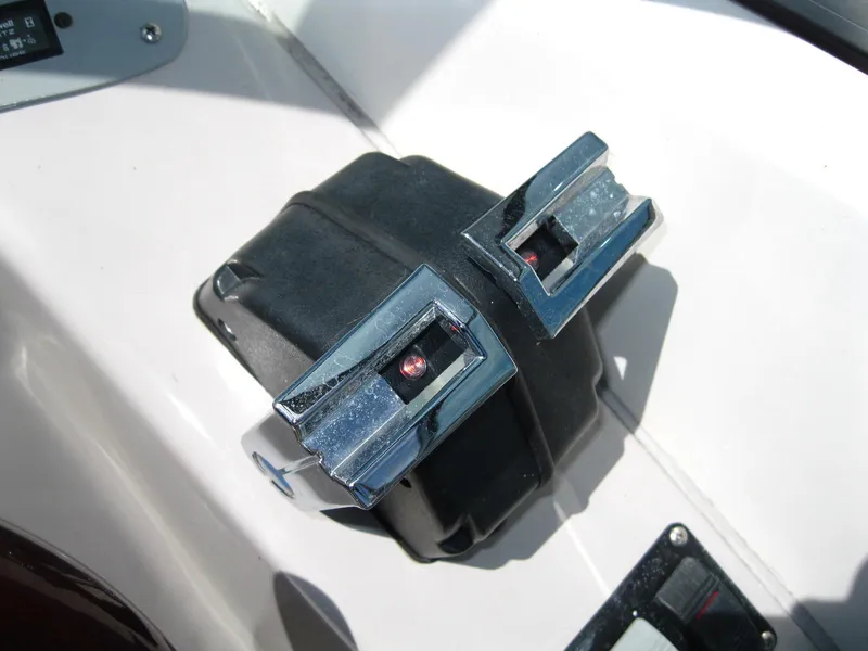 Slide: The Image of Throttle controls on a 2005 Chaparral 280 SSi boat dashboard. - 16