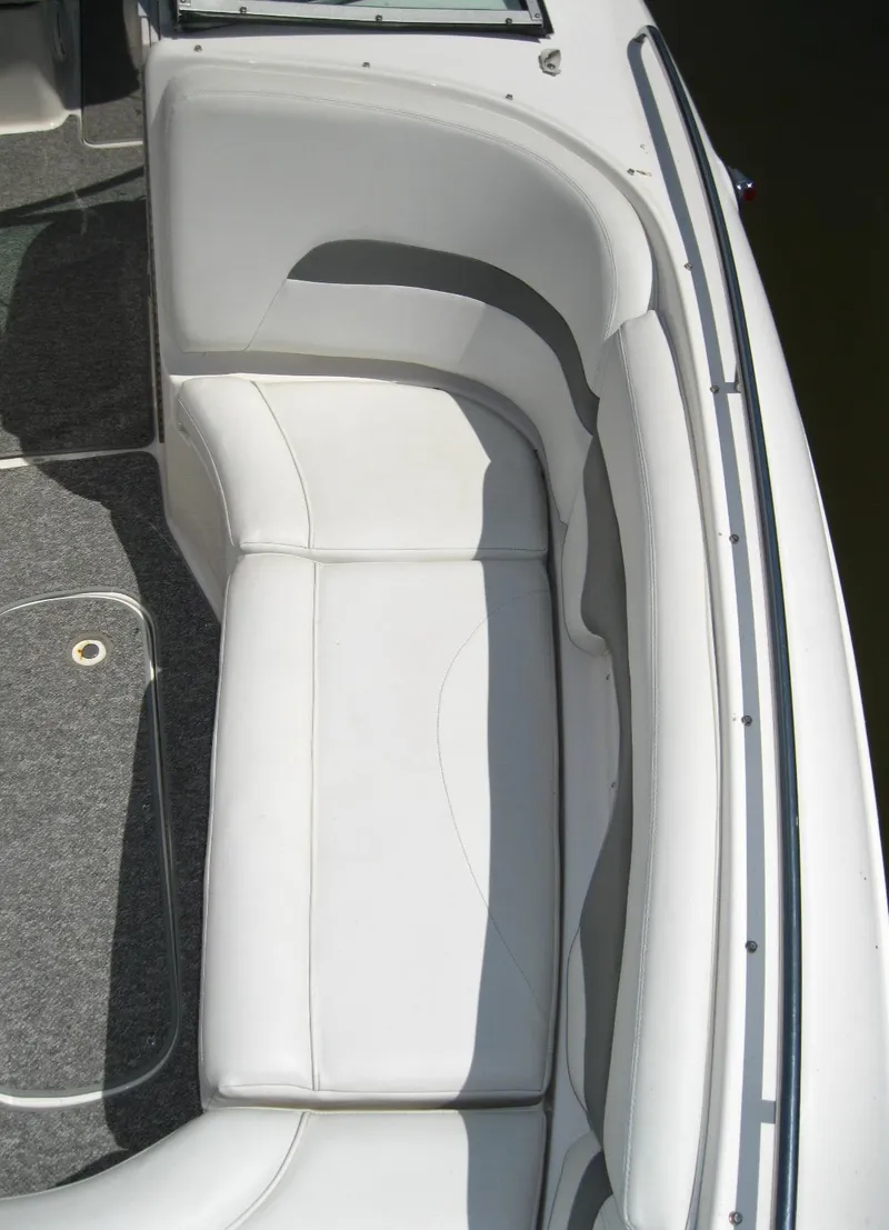 Slide: The Image of 2005 Chaparral 280 SSi boat interior with white cushioned seating. - 23