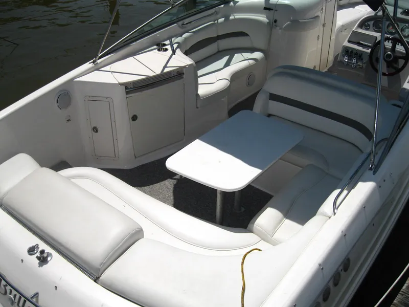 Slide: The Image of 2005 Chaparral 280 SSi boat interior with white seating and table. - 6