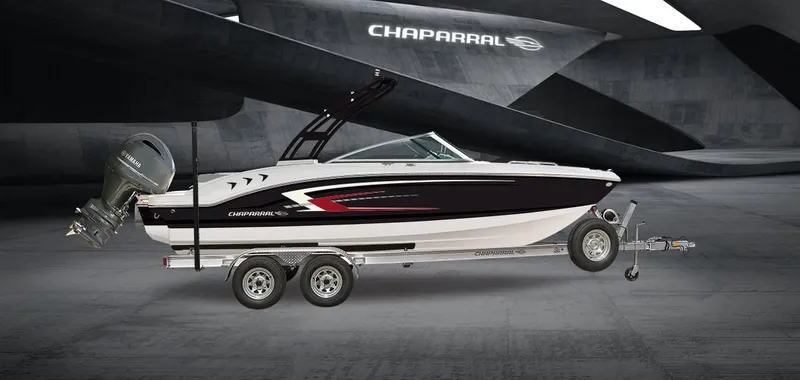 Slide: The Image of 2025 Chaparral 21 SSi OB boat on trailer, sleek design, modern graphics, outdoor setting. - 17