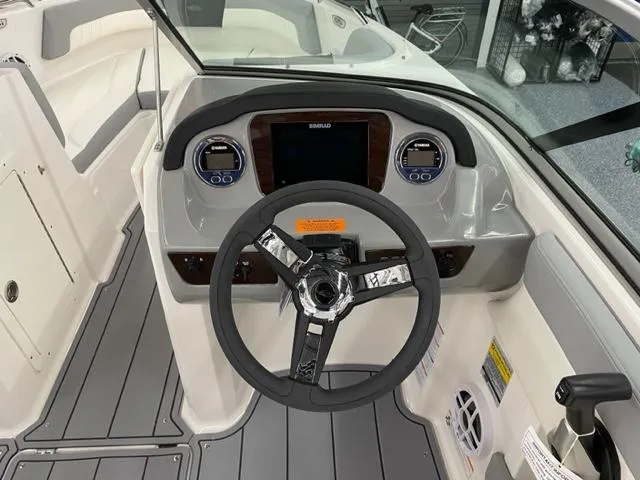 Slide: The Image of 2025 Chaparral 21 SSi OB boat dashboard with modern steering and controls. - 6