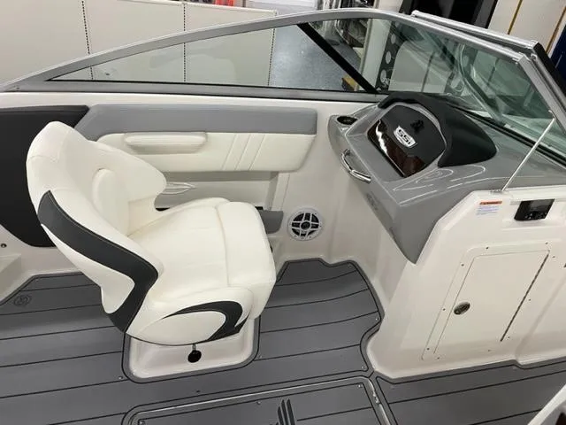 Slide: The Image of 2025 Chaparral 21 SSi OB boat interior with white seating and modern dashboard. - 7