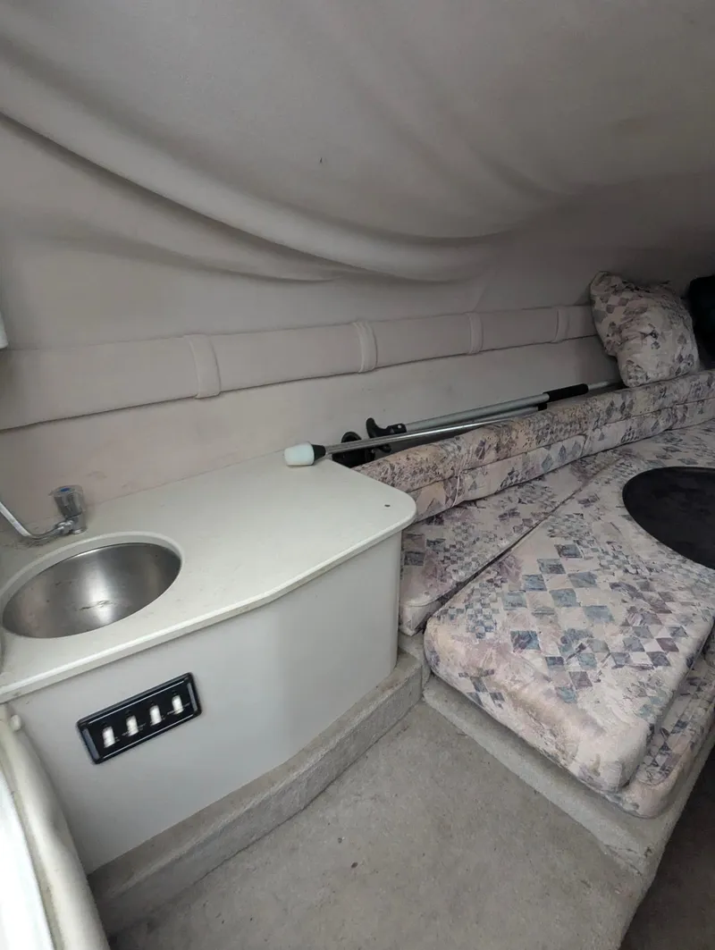 Slide: The Image of 1999 Crownline 266 CCR cabin interior with sink and patterned seating. - 7