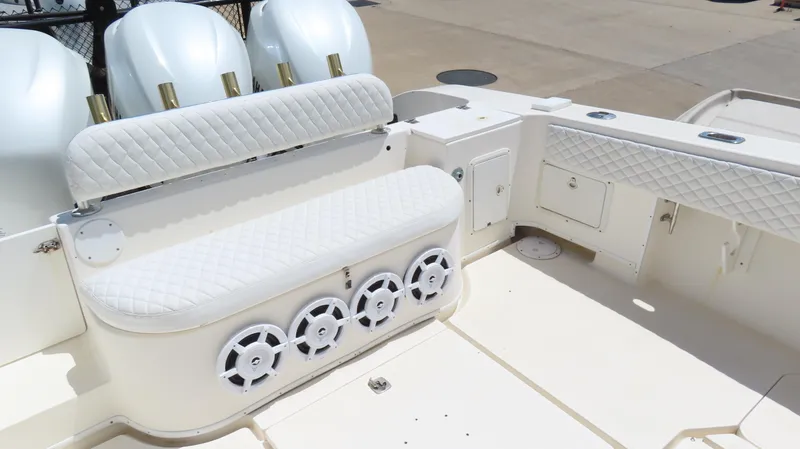 Slide: The Image of 2002 Fountain 38 TE boat interior with white seating and multiple speakers. - 10