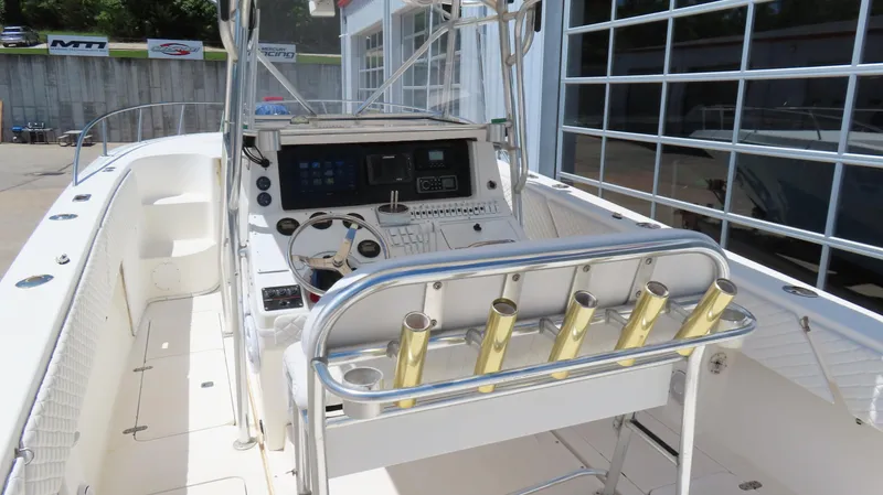 Slide: The Image of 2002 Fountain 38 TE boat cockpit with steering wheel and rod holders. - 12